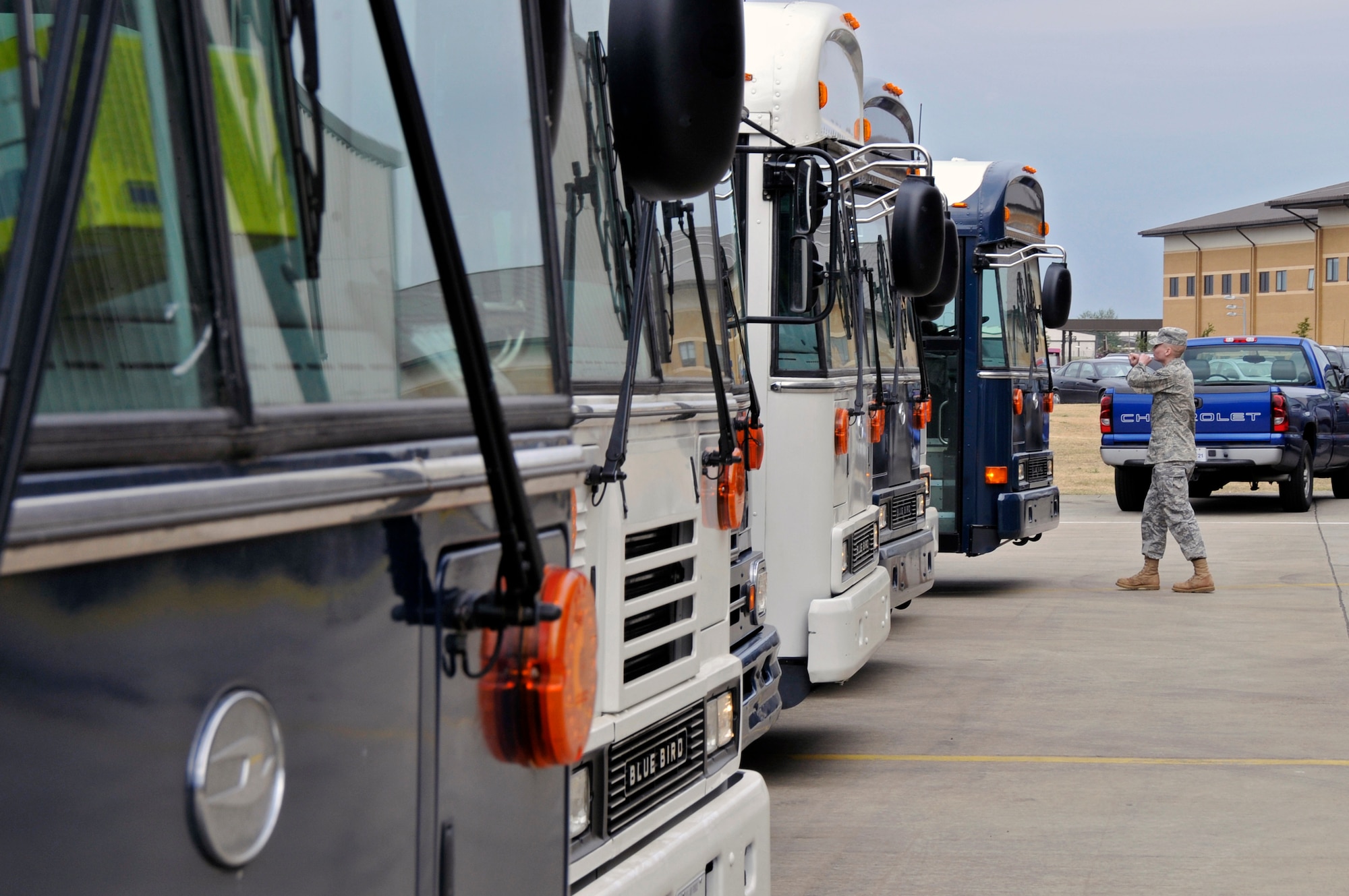 ROYAL AIR FORCE LAKENHEATH, England -- An Airman from the 48th Logistics Readiness Squadron, marshals in the buses carrying the returning Airmen here May 13, 2009. Over 250 Airmen, primarily from the 492nd Fighter Squadron returned from a four month deployment to Afghanistan in support of Operation Enduring Freedom. (U.S. Air Force photo by Airman 1st Class Perry Aston) 