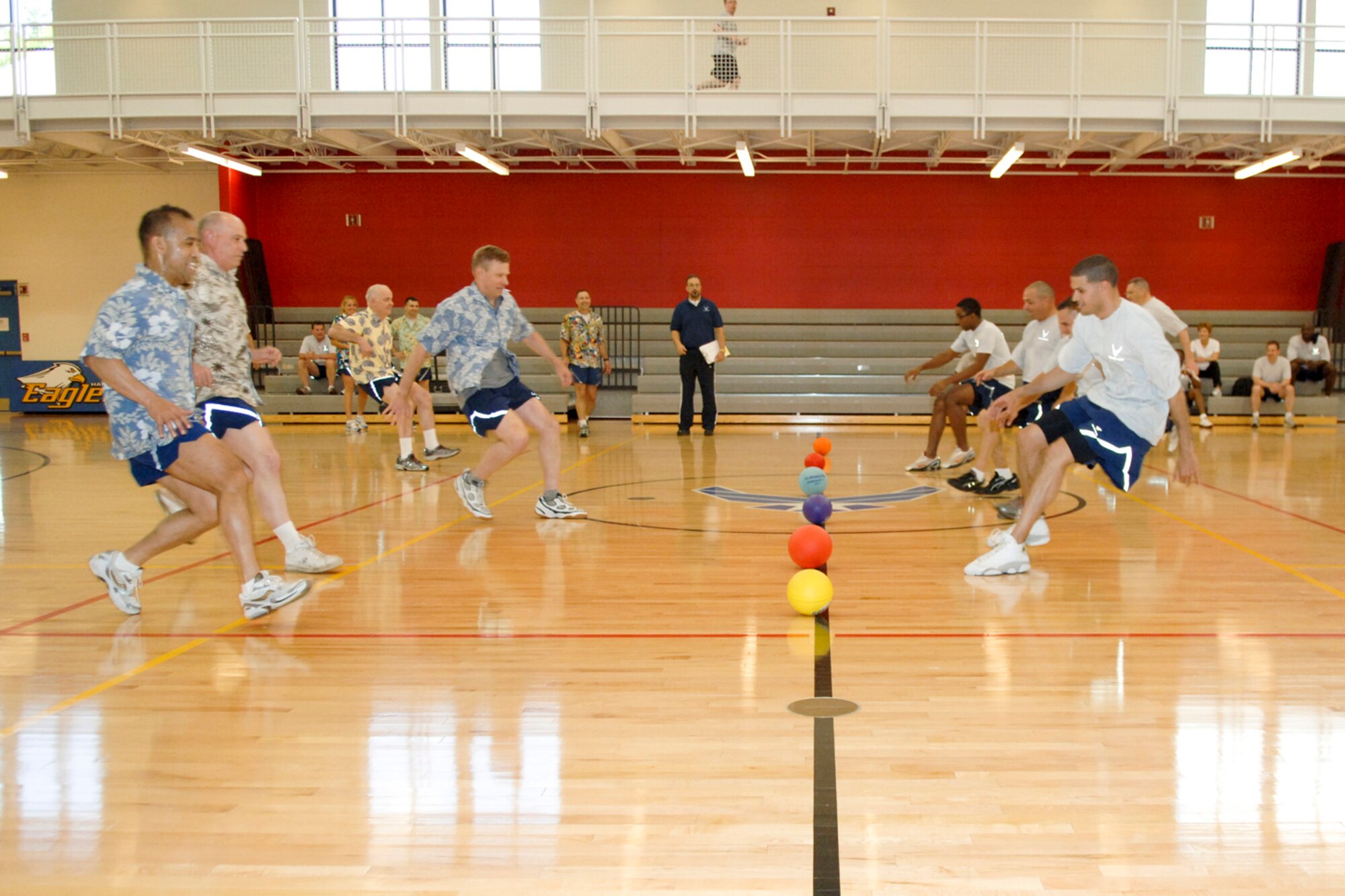 HANSCOM AIR FORCE BASE, Mass. – In the first challenge of Hanscom’s Olympic competition, the Eagles (left) square off against members of the Top 3 (right) in a game of dodgeball at the Fitness Center May 11. The Top 3 earned bragging rights at the end of the competition with victories in two out of three matches. The Olympics will take place through May 21, and will feature competition between the base's five wings, Air Force Research Laboratory, Electronic Systems Center staff and joint service personnel.  (U.S. Air Force photo by Rick Berry) 