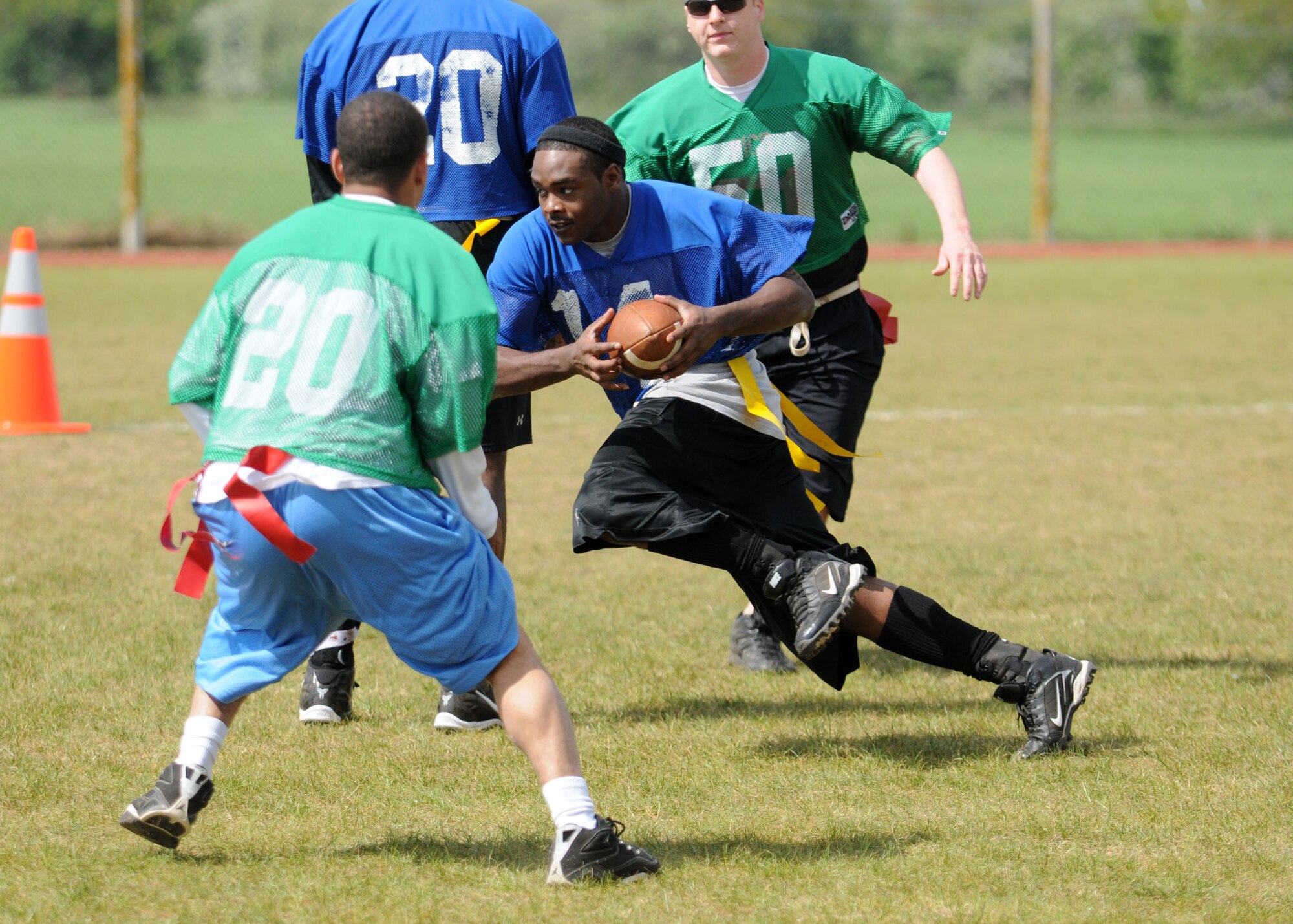 Senior Airman Chris Murray, 100th Security Forces Squadron, slices through the 48th Security Forces Squadron, RAF Lakenheath’s defense during a flag football game at Heritage Park May 12, 2009, at RAF Mildenhall, England. The 100th SFS dismantled the 48th SFS with a final score of 56-0. The game was held as a part of “Police Week” events which is a weeklong tribute to all fallen officers across the nation. (U.S. Air Force photo by Staff Sgt. Jerry Fleshman)
