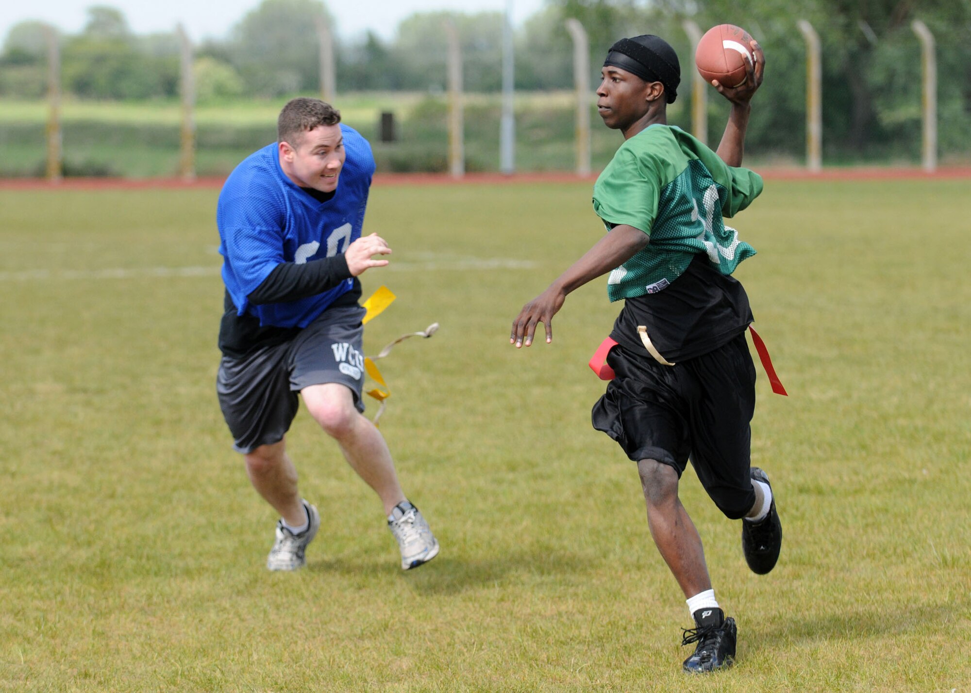 First Lt. Steven Brenoskie, 100th Security Forces Squadron, hunts down Airman Brian Walters, 48th Security Forces Squadron, RAF Lakenheath, during a friendly game of flag football between the two security forces squadrons at Heritage Park May 12, 2009, at RAF Mildenhall, England. The 100th SFS crushed the 48th SFS with a final score of 56-0. The game was held as part of “Police Week” running from May 11 to 15 which is to pay tribute to fallen officers across the nation. (U.S. Air Force photo by Staff Sgt. Jerry Fleshman)