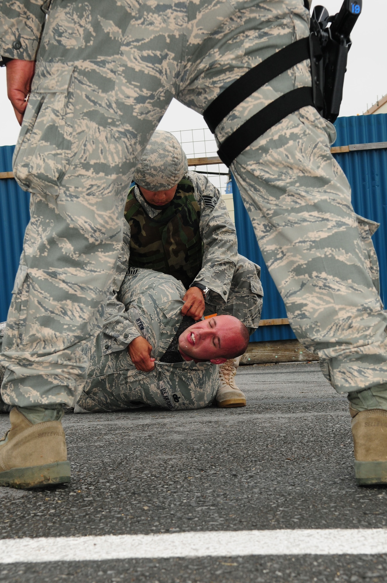 Staff Sgt. Joshua Tyquiengco, 18th Security Forces Squadron, apprehends a simulated bank robber during Beverly High 09-2 Local Operational Readiness Exercise May 12. The LORE tests base personnel on their readiness for real world emergency/combat events. (U.S. Air Force photo/Staff Sgt. Lakisha A. Croley)