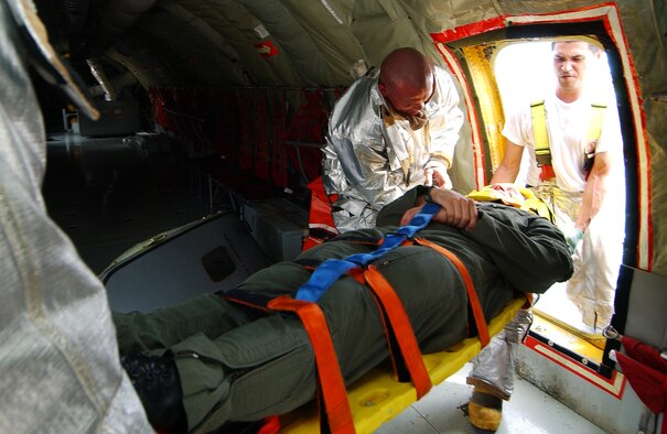 Firefighters from the 18th CES extract an injured pilot from a simulated aircraft/vehicle collision during Beverly High 09-2 Local Operational Readiness Exercise May 12 at Kadena Air Base, Japan. The LORE tests base personnel on their combat readiness for real world emergency/combat events. (U.S. Air Force photo/Tech. Sgt. Rey Ramon) 