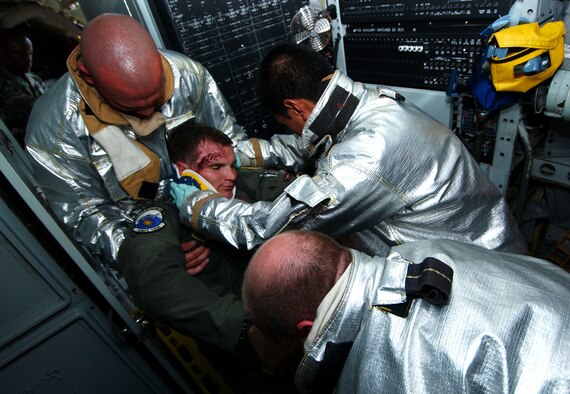 Firefighters from the 18th CES extract a simulated injured pilot to a field treatment team for critical care during Beverly High 09-2 Local Operational Readiness Exercise May 12 at Kadena Air Base, Japan. The LORE tests base personnel on their combat readiness for real world emergency/combat events. (U.S. Air Force photo/Tech. Sgt. Rey Ramon) 