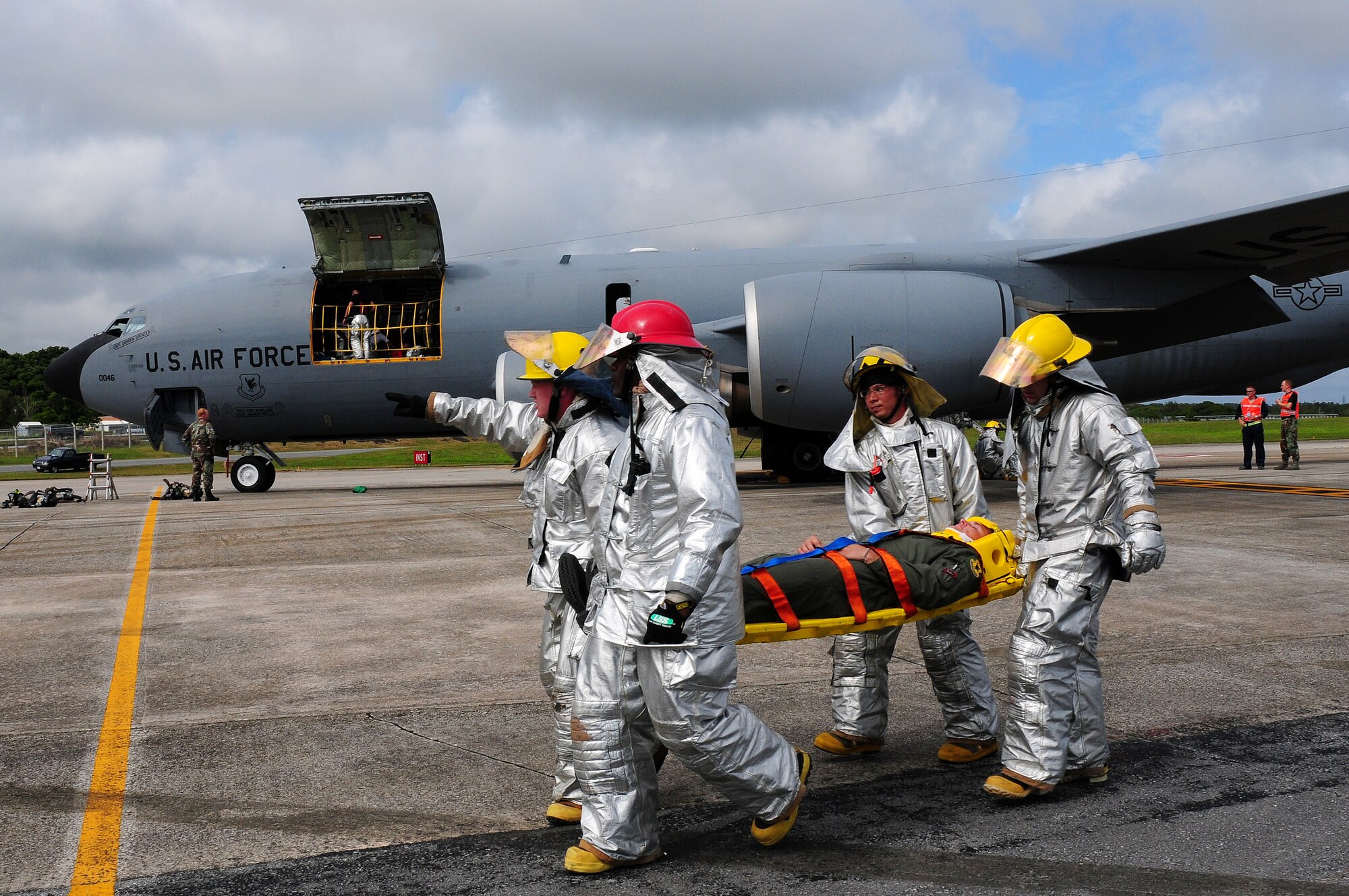 Firefighters from the 18th Civil Engineer Squadron rush the pilot to a field treatment team for critical care during Beverly High 09-2 Local Operational Readiness Exercise May 12. The LORE tests base personnel on their combat readiness for real world emergency/combat events.
(U.S. Air Force photo/Airman 1st Class Amanda Grabiec) 
