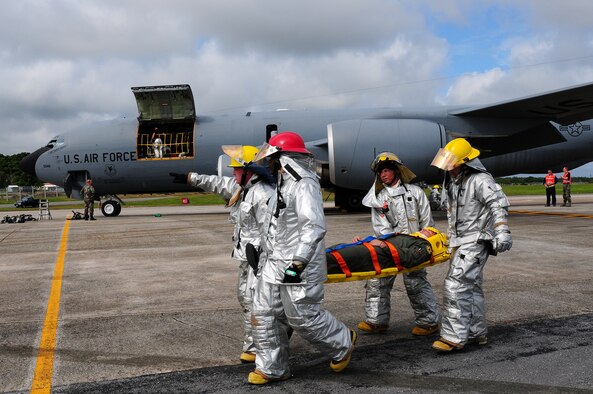 Firefighters rush a pilot to a field treatment team for critical care during Beverly High 09-2 Local Operational Readiness Exercise May 12 at Kadena Air Base, Japan. The LORE tests base personnel on their combat readiness for real world emergency/combat events. (U.S. Air Force photo/Airman 1st Class Amanda Grabiec) 