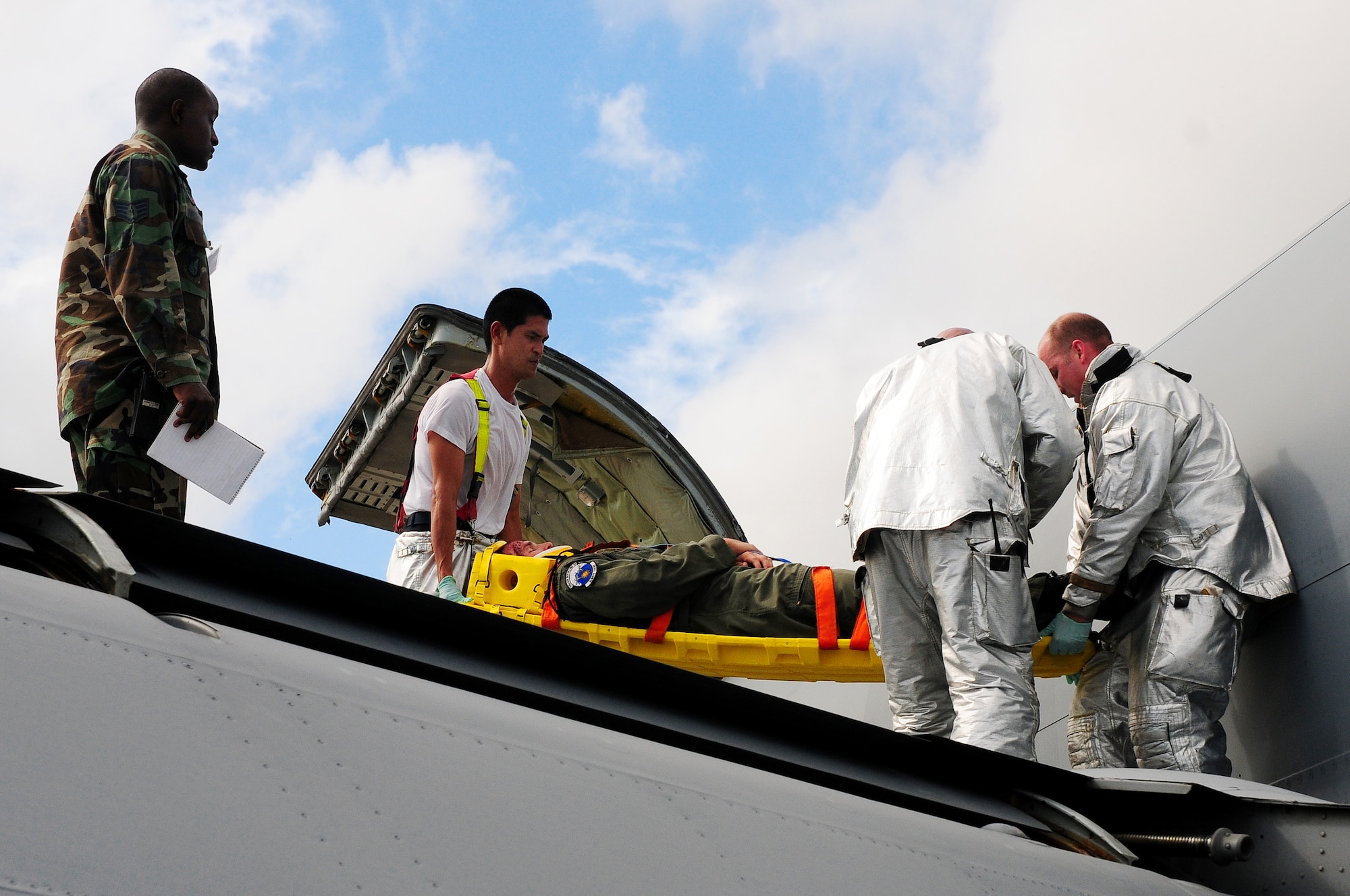 Firefighters from the 18th Civil Engineer Squadron work together to rescue an injured pilot in a simulated aircraft/vehicle collision during Beverly High 09-2 Local Operational Readiness Exercise May 12. The LORE tests base personnel on their combat readiness for real world emergency/combat events.
(U.S. Air Force photo/Airman 1st Class Amanda Grabiec) 
