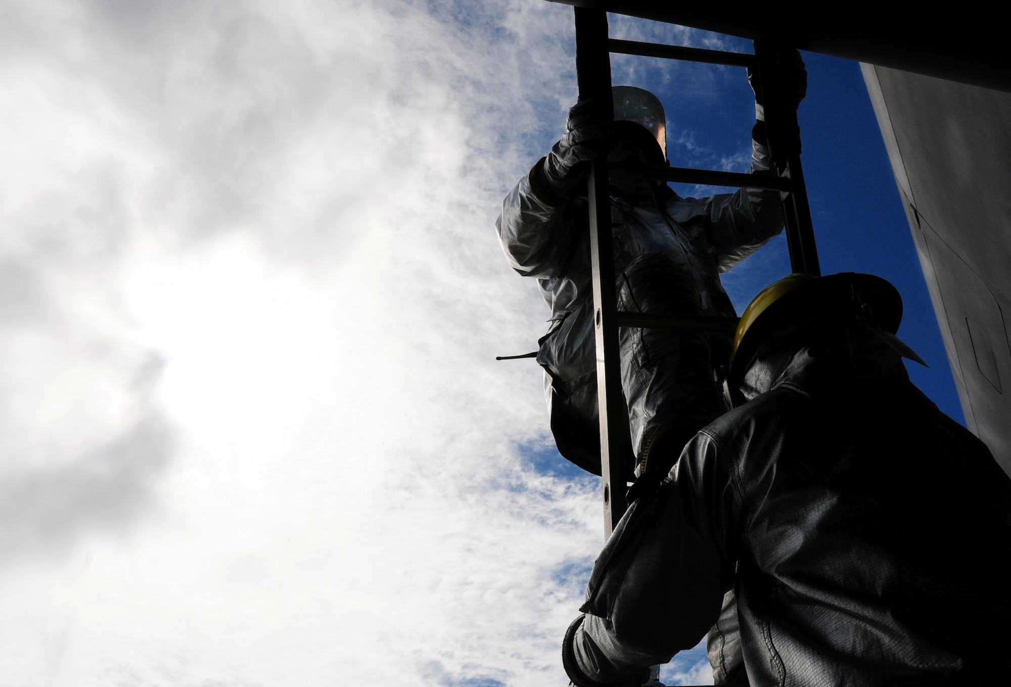 Firefighters from the 18th Civil Engineer Squadron scale up a ladder to rescue the aircrew from a simulated aircraft/vehicle collision during Beverly High 09-2 Local Operational Readiness Exercise May 12. The LORE tests base personnel on their combat readiness for real world emergency/combat events.
(U.S. Air Force photo/Airman 1st Class Amanda Grabiec) 