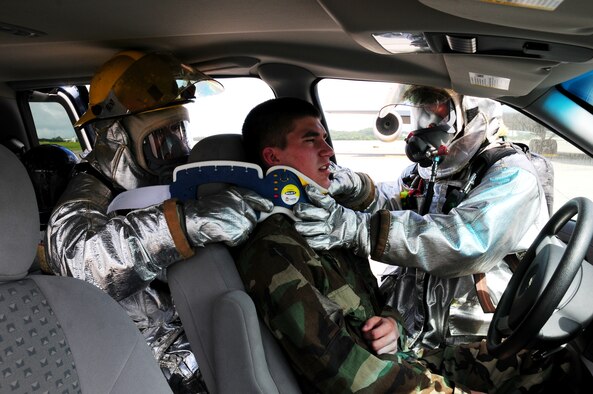 Firefighters from the 18th Civil Engineer Squadron rescue a victim from a simulated burning vehicle during Beverly High 09-2 Local Operational Readiness Exercise May 12 at Kadena Air Base, Japan. The LORE tests base personnel on their combat readiness for real world emergency/combat events. (U.S. Air Force photo/Airman 1st Class Amanda Grabiec) 