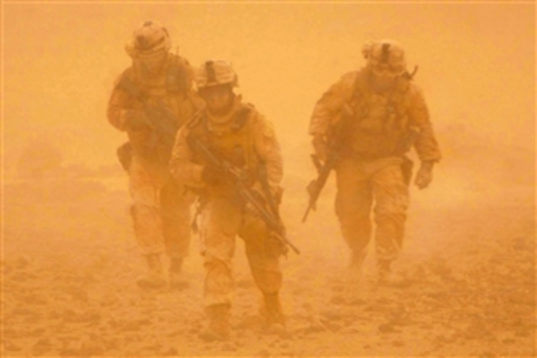 U.S. Marines make their way back to their vehicles in the middle of a sand storm after patrolling a nearby mountain ridge in Bakwa, Farah province, Afghanistan, May 3, 2009. The Marines are assigned to India Company, 3rd Battalion, 8th Marine Regiment, the ground combat element of Special Purpose Marine Air Ground Task Force Afghanistan.