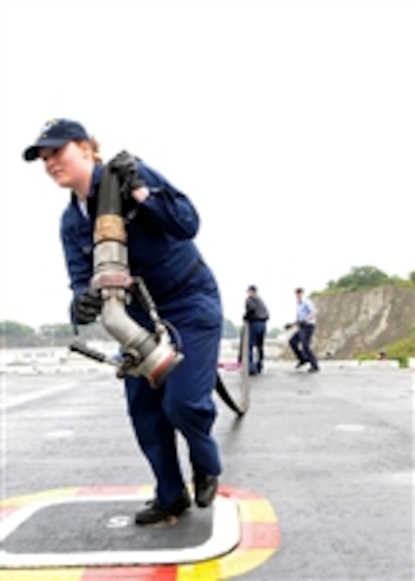U.S. Navy Airman Rachel Sekey lays out a jet fuel line aboard the aircraft carrier USS George Washington (CVN 73) in the Pacific Ocean on May 6, 2009.  The ship is underway conducting sea trials after completing a selected restricted availability at Fleet Activities Yokosuka, Japan.  