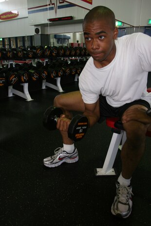 Lance Cpl. William B. Turner, an aircraft serviceman at the Visiting Aircraft Line here, pumps iron at the IronWorks Gym here Wednesday. As a Marine, it’s important to incorporate physical fitness and a good diet into your daily schedule, Turner said.