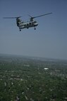 A CH-46 Sea Knight helicopter flies over Chicago suburbs during Marine Week as part of a demonstration May 12. The CH-46 took off at DuPage Airport in West Chicago carrying eight infantryman from the Chicago-based 2nd battalion, 24th Marines reserve unit and landed at Arlington Park. Upon landing the Marines exited the aircraft and executed a raid demonstration.
