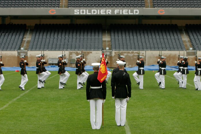– Soldier Field played host to the Marine Corps Silent Drill Platoon today as they performed to an audience of Chicagoans, including civilians, military personnel and cadets from the Junior Reserve Officers’ Training Corps program.
