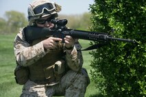 Lance Cpl. David Murray, 2nb battalion, 24th Marines, posts security during a raid demonstration at Arlington Park in Chicago May 12. The demonstration was a part of a week-long event dubbed 'Marine Week Chicago.' The events showcase what Marines do on the regular basis. Marines also volunteered throughout the area cleaning up parks and communitiy centers.