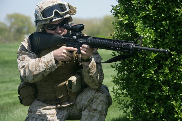 Lance Cpl. David Murray, 2nb battalion, 24th Marines, posts security during a raid demonstration at Arlington Park in Chicago May 12. The demonstration was a part of a week-long event dubbed 'Marine Week Chicago.' The events showcase what Marines do on the regular basis. Marines also volunteered throughout the area cleaning up parks and communitiy centers.
