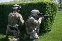 Staff Sgt. Eric Esparza and Lance Cpl. David Murray, Company F, 2nd battalion, 24th Marines, post security during a raid demonstration at Arlington Park in Chicago. The Chicago-based reserve Marines flew into the racetrack in a CH-46 Sea Knight helicopter and were picked up after the demonstration in an MV-22 Osprey.