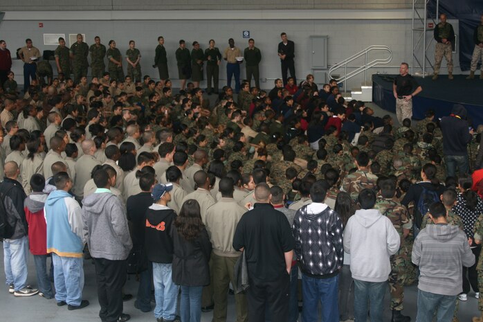 – Cadets from the Junior Reserve Officers’ Training Corps attend a demonstration of martial arts maneuvers by members of the Marine Corps’ Martial Arts Center of Excellence (MACE) at Soldier Field today. Retired Marine LtCol. Joseph Shusko, MACE Director, discusses the warrior mindset and traditions with this crowd of 800 young people. The demonstration was one of several throughout the city as part of the inaugural Marine Week, which runs through Sunday. The weeklong event provides the residents an opportunity to meet Marines and learn about their history and traditions.
