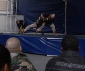 Sgt. Joshua Ott, instructor trainer, Martial Arts Center of Excellence, Quantico Va. demonstrates how to take down an enemy using Sgt. Steven Richardson, instructor trainer, MACE, Quantico, Va., during the MACE demonstration at Soldier Field May 13.