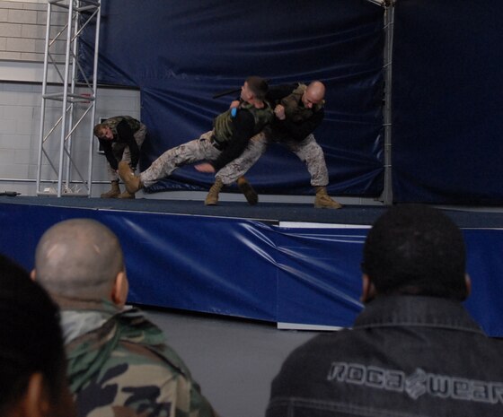 Sgt. Joshua Ott, instructor trainer, Martial Arts Center of Excellence, Quantico Va. demonstrates how to take down an enemy using Sgt. Steven Richardson, instructor trainer, MACE, Quantico, Va., during the MACE demonstration at Soldier Field May 13.
