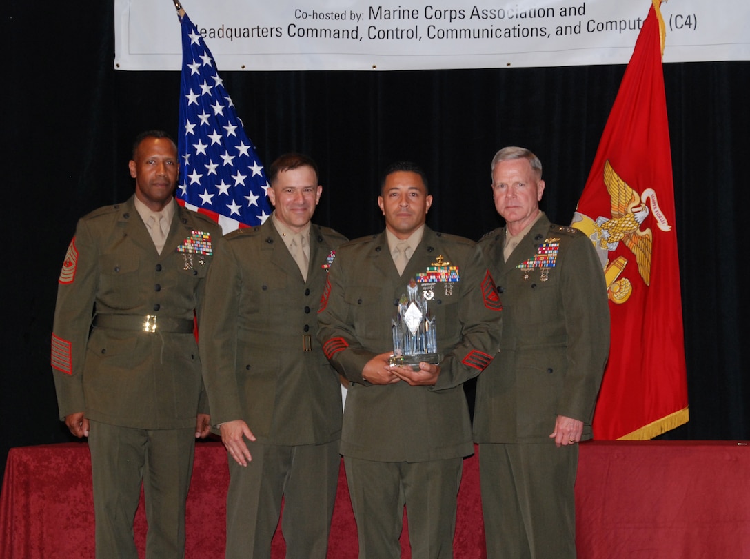 ARLINGTON, V.A. – Gunnery Sgt. Eric C. Hernandez (Second from right), Communications Chief for a company with 2d Marine Special Operations Battalion, is presented with the 2008 PFC Herbert A. Littleton Enlisted Communications Award trophy while standing shoulder to shoulder with (from left to right) MGySgt Byron M. Bissessar, U.S. Marine Corps Communications Chief, Brig. Gen. George J. Allen, C4 Director and Gen. James F. Amos, Assistant Commandant of the Marine Corps, here May 13.