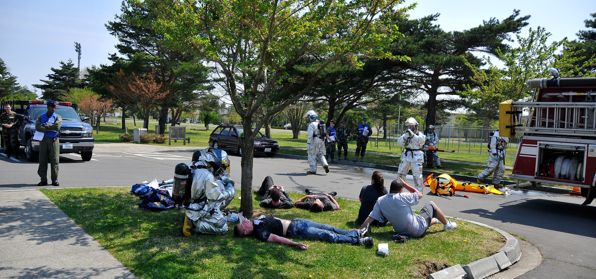 MISAWA AIR BASE, Japan -- Firefighters from the 35th Civil Engineer Squadron attend to simulated mass casualties during an all hazard response training exercise May 5, 2009. Exercises help military personnel maintain and practice the necessary skills and actions required in emergency situations.  (U.S. Air Force photo by Senior Airman Chad Strohmeyer) 