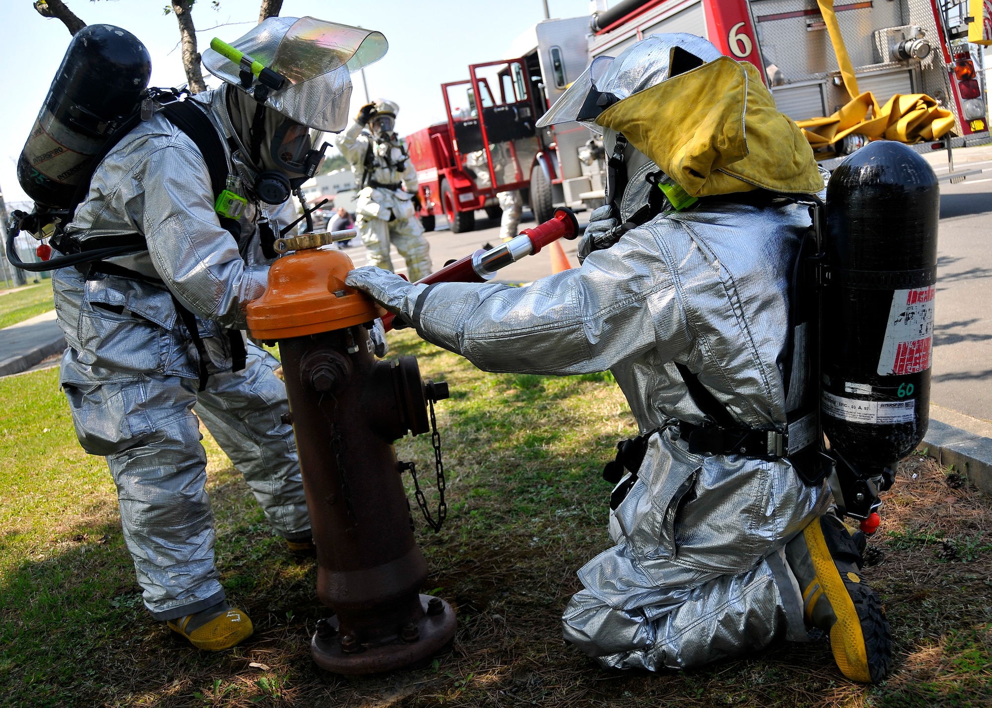 MISAWA AIR BASE, Japan -- Firefighters from the 35th Civil Engineer Squadron attach a special hose to a fire hydrant to hose down simulated wounded during an all hazard response training exercise May 5, 2009. Firefighters, security forces, medical personnel and explosive ordnance disposal teams were tested on their response to a chemical attack.  (U.S. Air Force photo by Senior Airman Chad Strohmeyer) 
