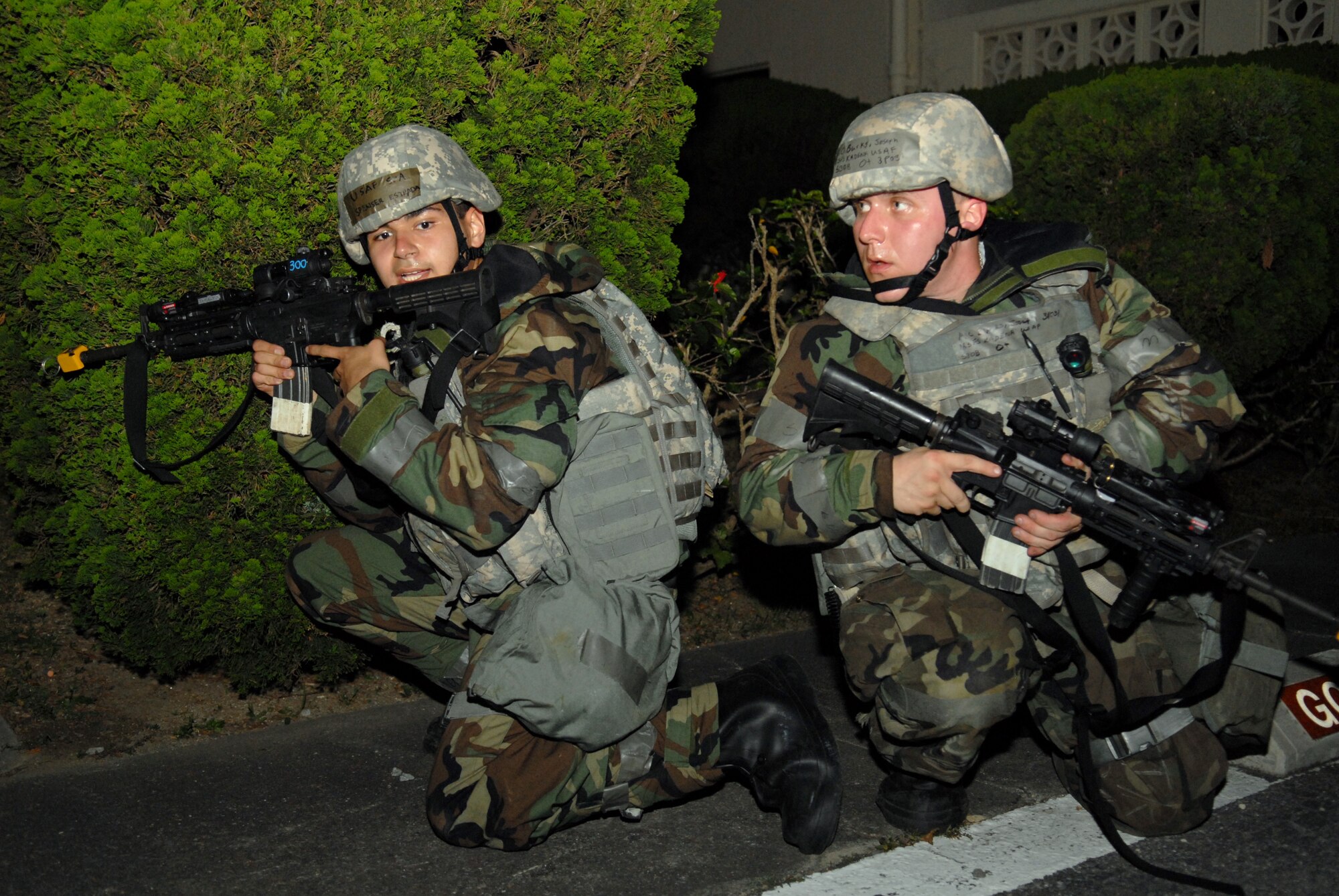 Senior Airman Spenser Estrada (left) and Airman 1st Class Joseph Burks (right), both from the 18th Security Forces Squadron, secure the area while responding to a simulated mortar attack during Beverly High 09-2 Local Operational Readiness Exercise at Kadena Air Base, May 14. The LORE tests base personnel on their combat readiness for real world emergency/combat events.
(U.S. Air Force photo/Tech. Sgt. Angelique Perez) 