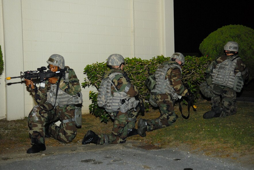 Members of the 18th Security Forces Squadron secure the area while responding to a simulated mortar attack during Beverly High 09-2 Local Operational Readiness Exercise at Kadena Air Base, May 14. The LORE tests base personnel on their combat readiness for real world emergency/combat events. (U.S. Air Force photo/Tech. Sgt. Angelique Perez)