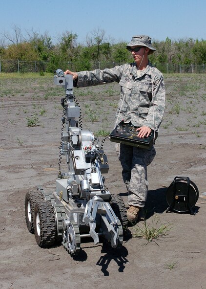 Senior Airman Rachel Redel demonstrates how an F6A robot works May 12 during an explosive ordnance disposal demonstration at Manas Air Base, Kyrgyzstan. The robot is used by the EOD flight for exploration of suspicious items. Airman Redel is assigned to the 377th Mission Support Group at Kirtland Air Force Base, N.M. (U.S. Air Force photo/Tech. Sgt. Elizabeth Weinberg)