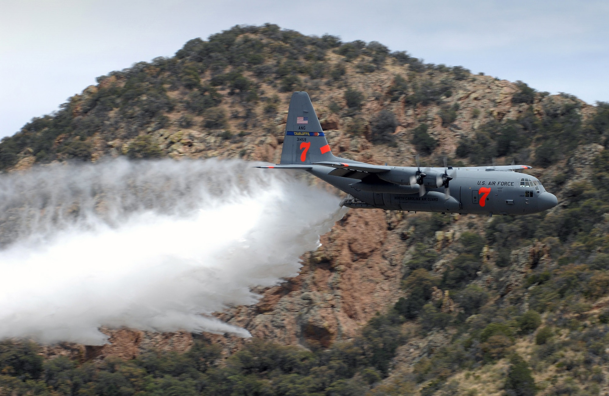 A C-130 Hercules drops "fire retardant" from a Modular Airborne Fire Fighting System near Tucson, Ariz., May 8 to finalize MAFFS certification by the U.S. Forestry Service.  Air Force Reserve and Air National Guard aircrews flew training missions from sun up to sundown in the annual event. (U.S. Air Force photo/Tech. Sgt. Alex Koenig)