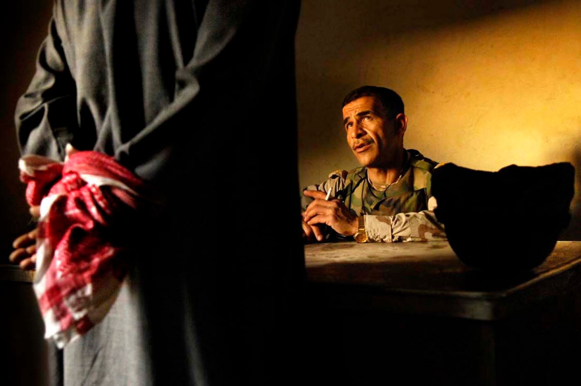 The Stacy Pearsall Combat Photo Gallery — A Military Photographer of the Year, Pearsall’s work has been viewed worldwide. Lt. Col. Kahlil of the Iraqi army, 4th Battalion, 2nd Brigade, 5th Division, questions a detainee during a three-day operation in Old Baqubah, Iraq, on March 9, 2007. (photo by Staff Sgt. Stacy Pearsall)
