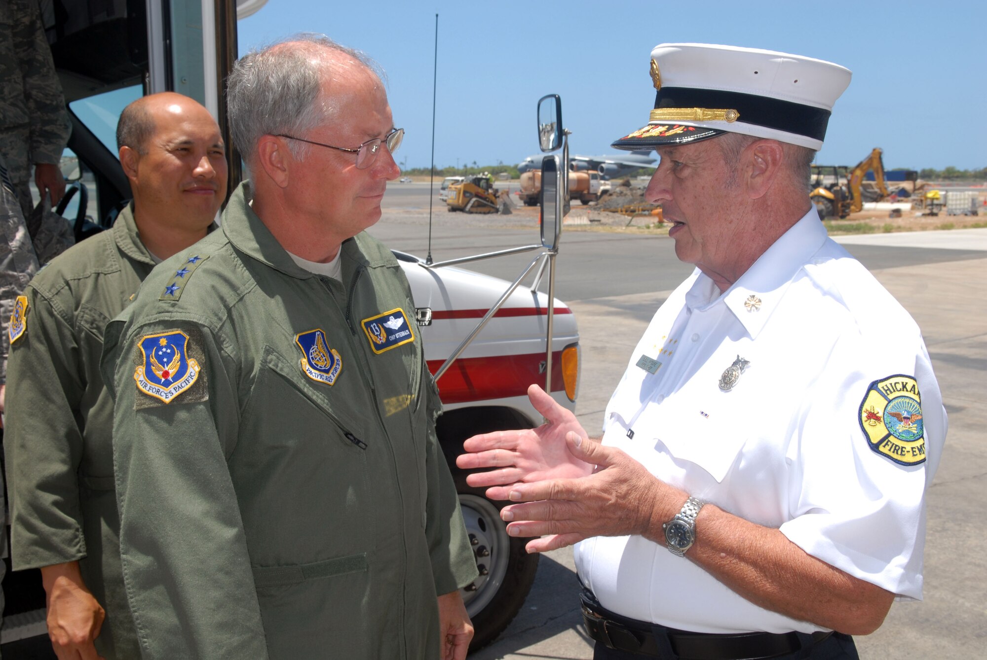 HICKAM AIR FORCE BASE, Hawaii -- Willam Moore Jr., 15th Civil Engineer Squadron Fire and Emergency Services chief (right), greets Lt. Gen. Chip Utterback, 13th Air Force commander, and Col. Giovanni Tuck, 15th Airlift Wing commander, during General Utterback's base visit May 12. (U.S. Air Force photo by Ed Foster)