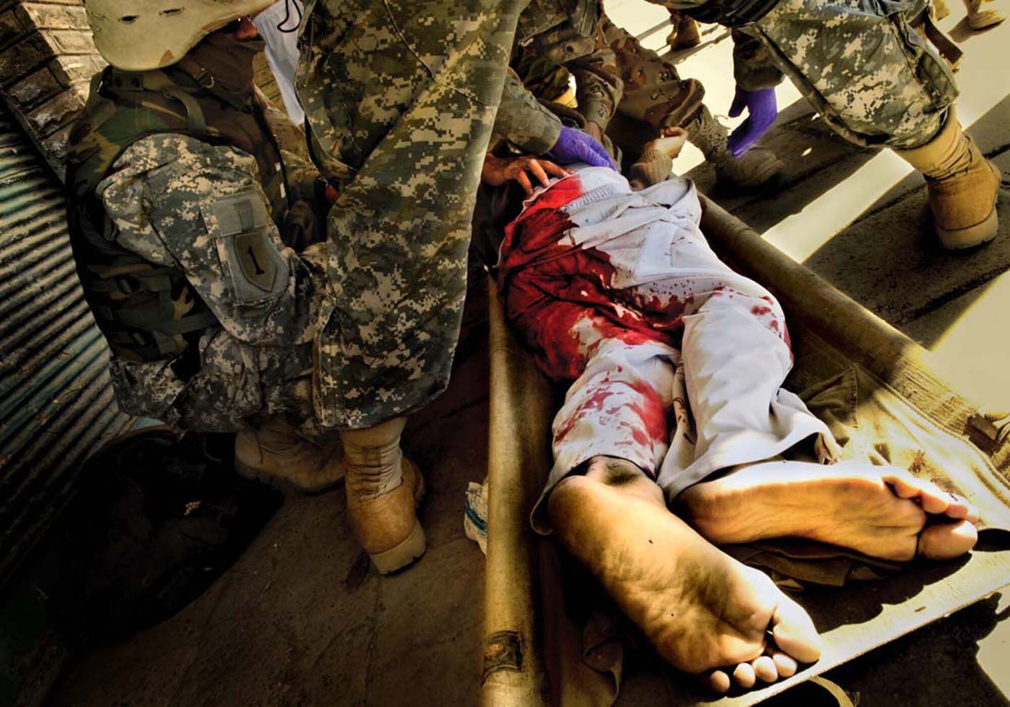 The Stacy Pearsall Combat Photo Gallery — A Military Photographer of the Year, Pearsall’s work has been viewed worldwide. Iraqi army medics provide medical assistance to an enemy fighter after he was shot several times during a heated gun battle in Baqubah, Iraq, on March 11, 2007. (photo by Staff Sgt. Stacy Pearsall)
