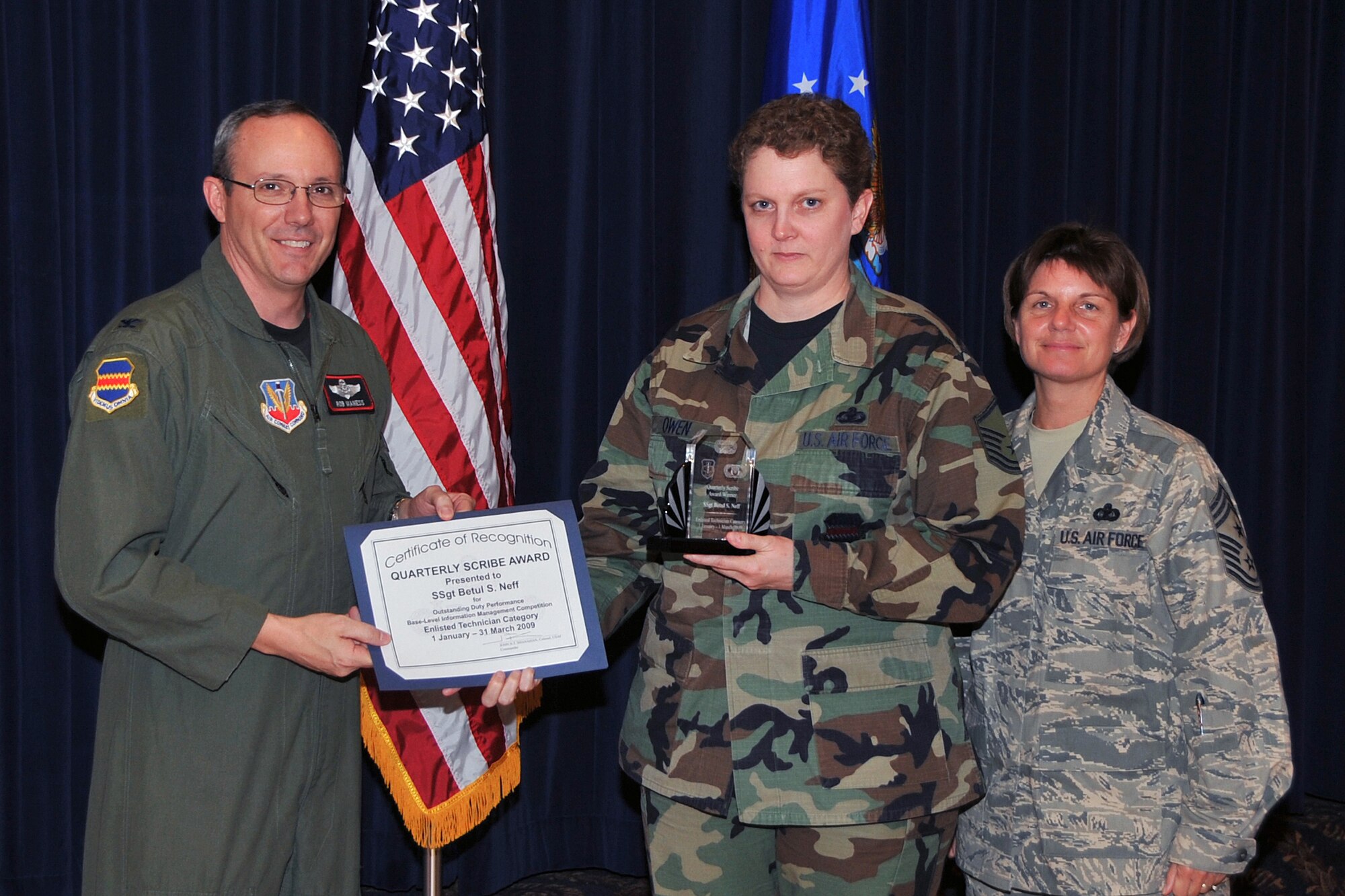 OFFUTT AIR FORCE BASE, Neb. ? Master Sgt. Paula R. Owen, 55th Maintenance Group, accepts the Enlisted Technician Scribe Award on behalf of Staff Sgt. Betul Neff, 55th Maintenance Group, from Col. Robert L. Maness, 55th Wing vice commander, as Command Chief Master Sgt. Lisa A. Sirois looks on during the Scribe Awards Luncheon at the Patriot Club here May 13. Sergeant Neff earned the honor for outstanding achievement within her career field. Sergeant Neff distinguished herself by maintaining the Emergency Maintenance Operation Center server providing critical mission data, which enabled more than 400 sorties to be flown. Sergeant Neff also created 60 Active Directory security groups, securing critical information and preventing wrongful disclosure of Privacy Act information. Air Force Photo by Jeff W. Gates