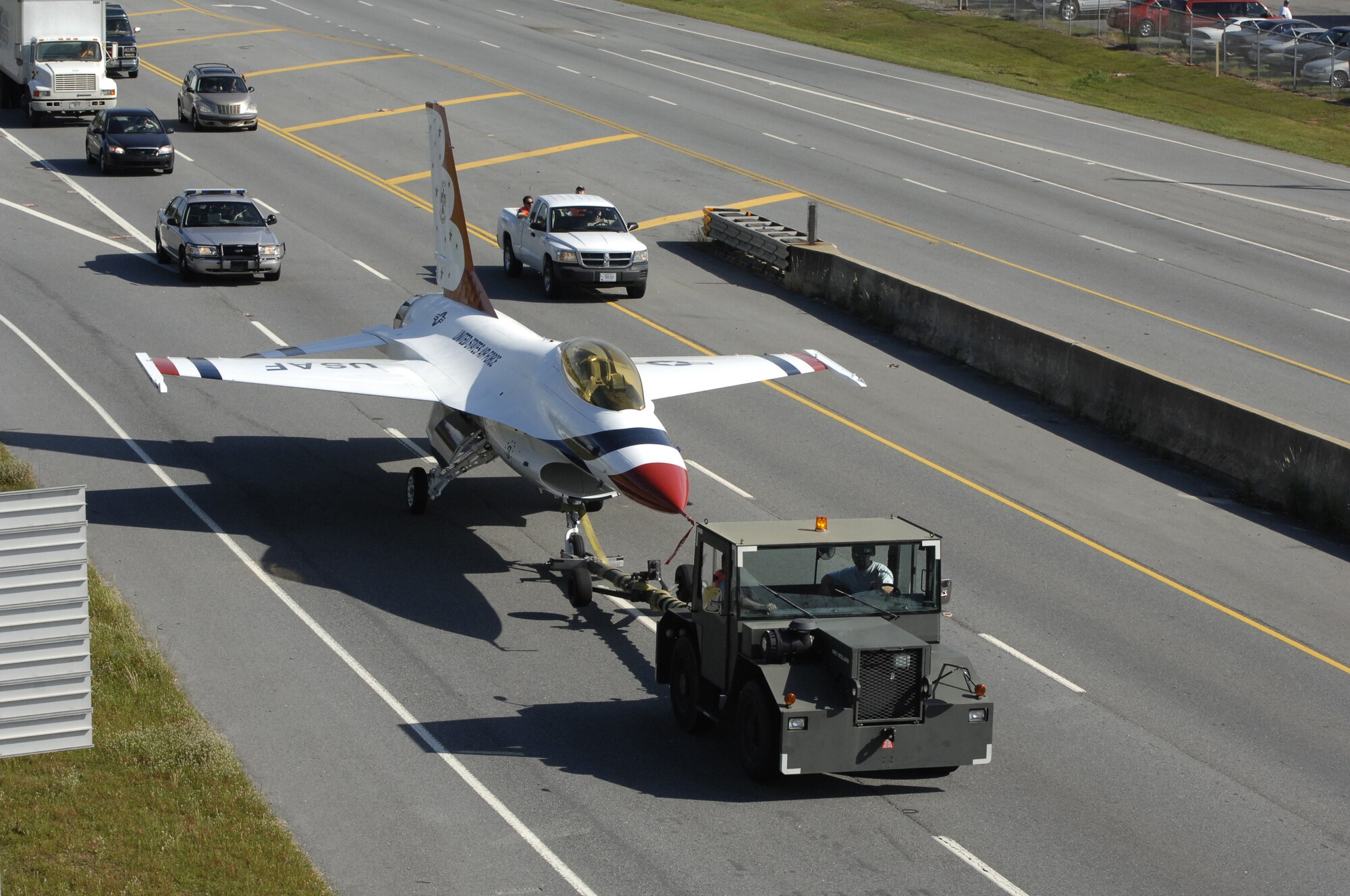 An F-16, formerly part of the Thunderbirds aerial demonstration team from 1982-1991, is towed down 247 to the Museum of Aviation where it is now on display in the Century of Flight hangar. U. S. Air Force photo by Claude Lazzara