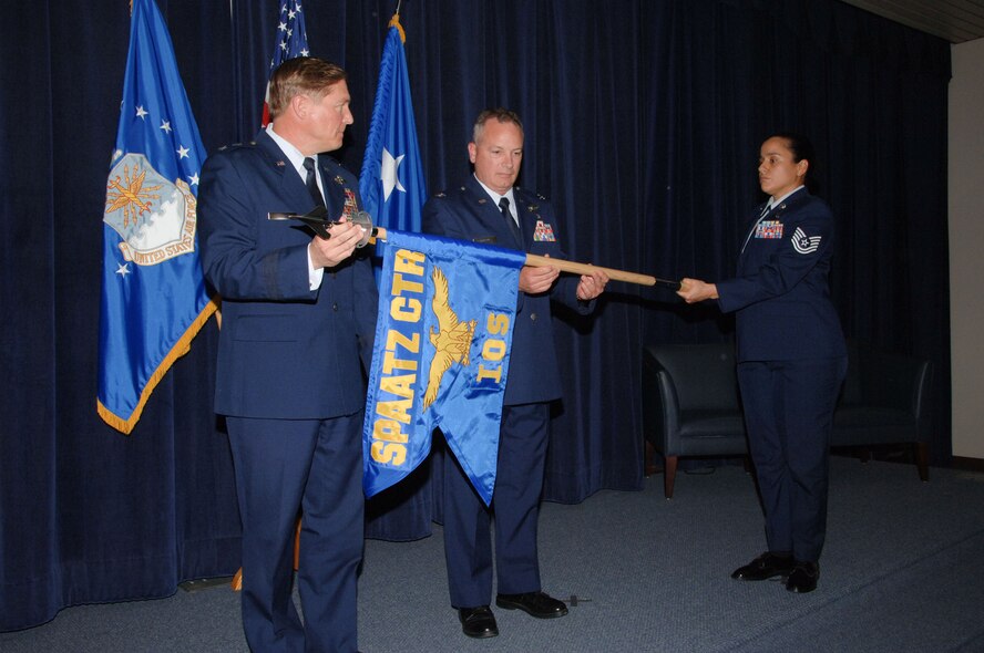 Maj. Gen. Maurice Forsyth, Air War College commandant and Spaatz Center commander, and Col. Michael Homan, International Officer School commandant, roll the Spaatz Center-IOS flag during the school’s assumption of command ceremony at the Air University Academic Facility auditorium May 8. Assisting them was Tech. Sgt. Hortencia Crutcher of IOS. The ceremony marked IOS becoming an independent school under Spaatz Center, as opposed to falling under the center’s Educational Support Squadron. Spaatz Center also includes Air Command and Staff College, Squadron Officer College and the School of Advanced Air and Space Studies. (U.S. Air Force photo/Melanie Rodgers Cox)