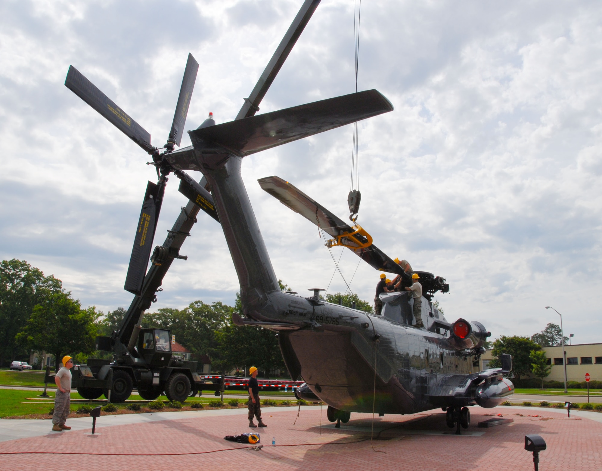 Workers mount the rotors on a new addition to Maxwell’s Air Park. The MH-53 Pave Low helicopter is scheduled to be dedicated June 8 at the park. The aircraft comes to Maxwell from the 20th Special Operations Squadron with its last mission served in Iraq. The aircraft was involved in the May, 1975 assault on Koh Tang Island following seizure of the U.S.S. Mayaguez and its crew by Cambodian Khmet Rouge forces, and was the last helicopter to leave Cambodia as it carried out the last load of Marine guards from the American embassy in Phnom Phen in Operation Eagle Pull. It is also thought to have conducted the first operational Pave Low mission of "low-level, long-range and undetected penetration into denied areas" when it rescued a priest who crashed his light aircraft on a snow-covered mesa breaking his ankle. The park was originally proposed in February, 1982 by then Air University Commander Lt. Gen. Charles Cleveland. (U.S. Air Force photo/Jamie Pitcher)