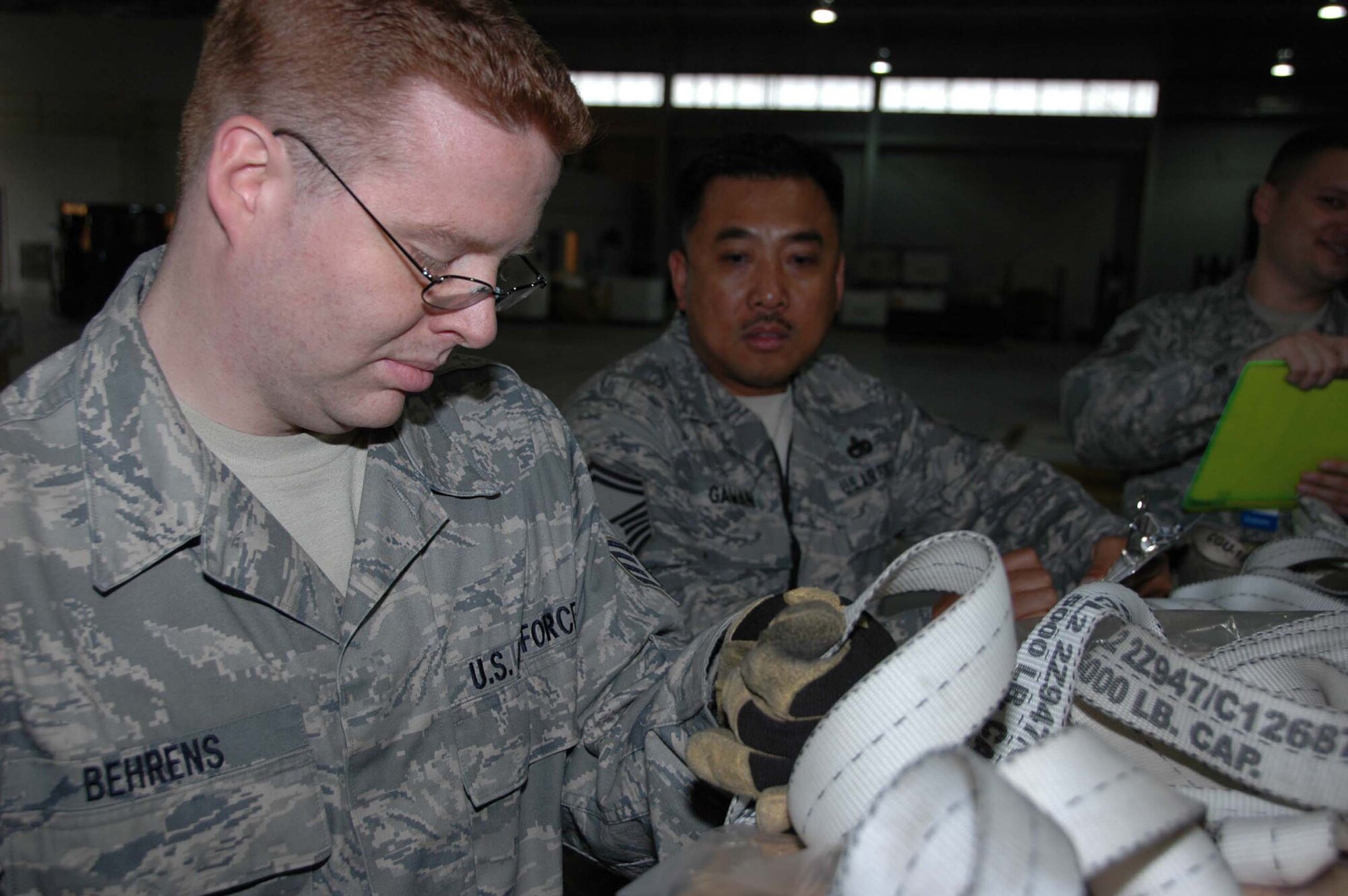 MCGUIRE AIR FORCE BASE, N.J. -- Staff Sgt. Steven Behrens, an air freight supervisor, ties down a pallet as Logistics Standardization and Evaluation Program inspector, Senior Master Sgt. Phillip Gawan observes during the May 4-11 inspection held here. (U.S. Air Force photo/Master Sgt. Donna T. Jeffries)