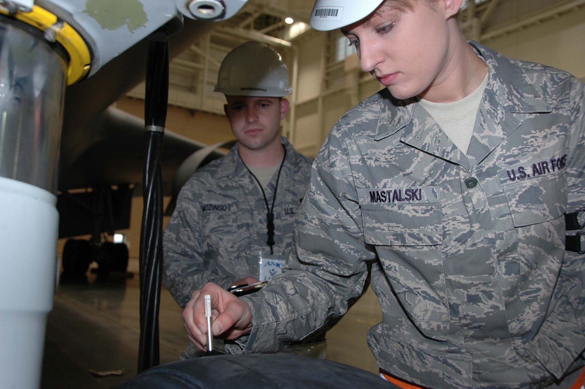MCGUIRE AIR FORCE BASE, N.J. -- Staff Sgt. Lydia Mastalski a KC-10 crew chief checks the air pressure in a KC-10 Extender front tire while Logistics Standardization and Evalutaion Program inspector Technical Sgt. Donald Mozingo takes note during the recent LSEP assessment held here. (U.S. Air Force photo/Master Sgt. Donna T. Jeffries)