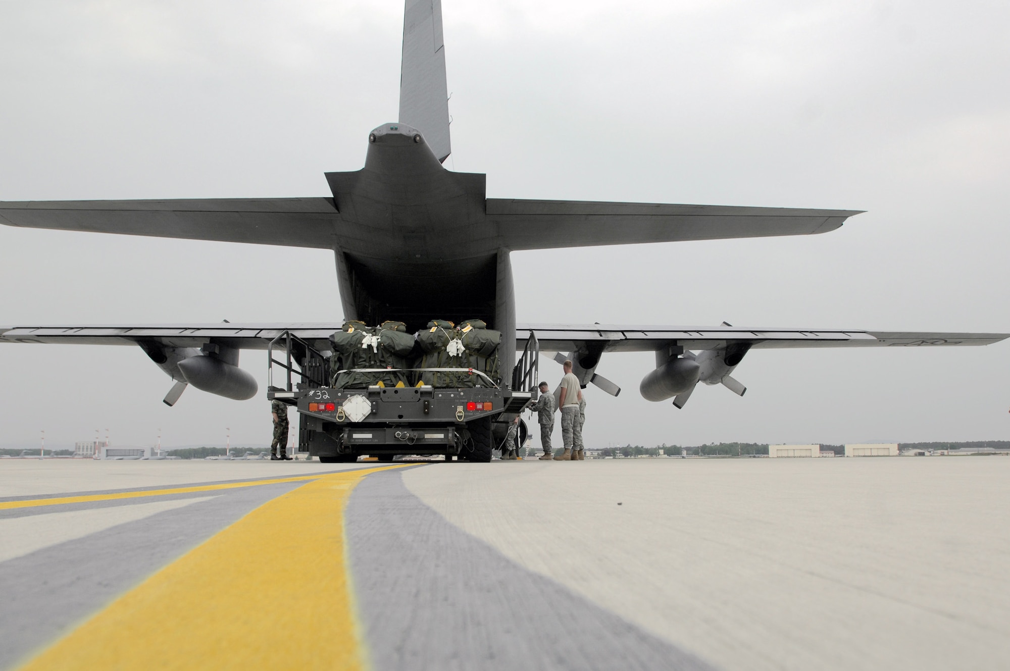 Members of the 1st Combat Communication Squadron and 37th Airlift Squadron prepare to load lifesaving equipment onto a C-130 Hercules May 9 at Ramstein Air Base, Germany. The Airmen supported NASA's launch of Space Shuttle Atlantis May 11. (U.S. Air Force photo/Senior Airman Kenny Holston)