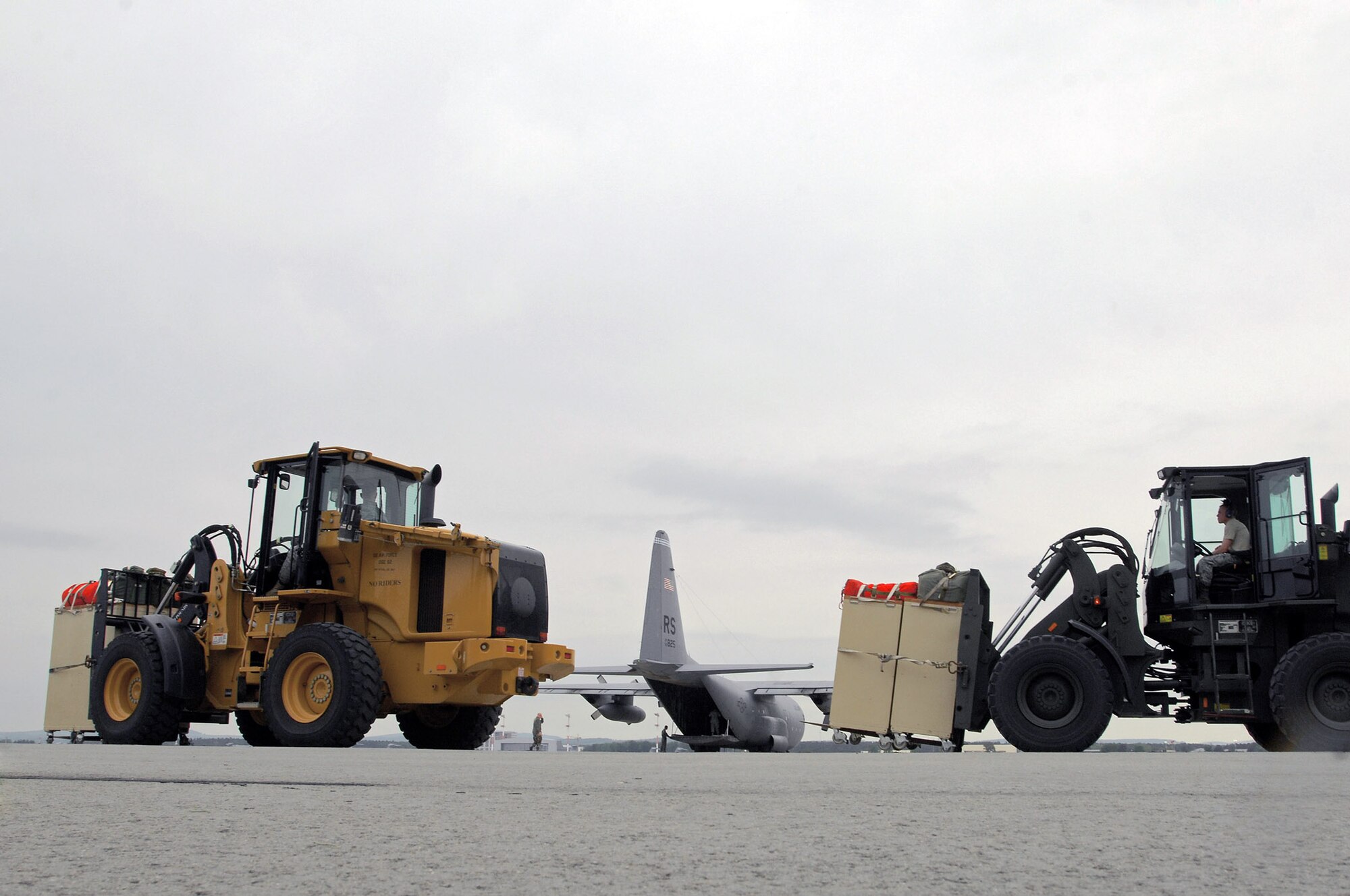 1st Combat Communication Squadron Airmen prepare to load lifesaving equipment onto a C-130 Hercules May 9 at Ramstein Air Base, Germany. The Airmen supported NASA's launch of Space Shuttle Atlantis May 11. (U.S. Air Force photo/Senior Airman Kenny Holston)