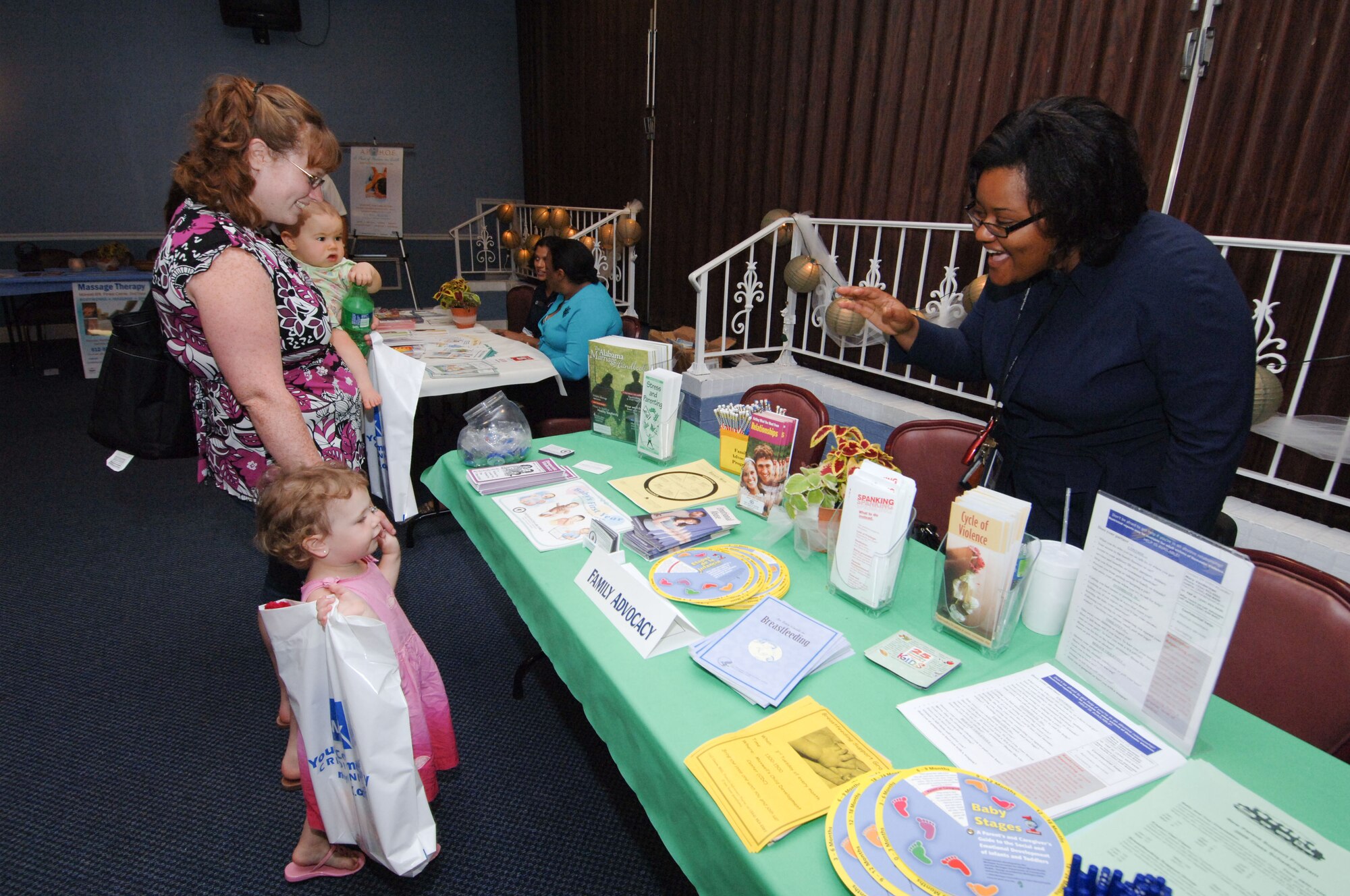 Lindsay Bieck, spouse of Staff Sgt. David Bieck, 42nd Security Forces Squadron, and daughters Emily and Ayla visit April Jones at the Family Advocacy booth during Military Spouse Appreciation Day May 8. The base-wide event at the Maxwell Event Center honored spouses with free food, door prizes, and give-a-ways. Base helping agencies were also in attendence with informational booths. The event is celebrated as part of National Military Appreciation Month, which also observes Memorial Day, Victory Day and Armed Forces Week.  (U.S. Air Force photo/Melanie Rodgers Cox)