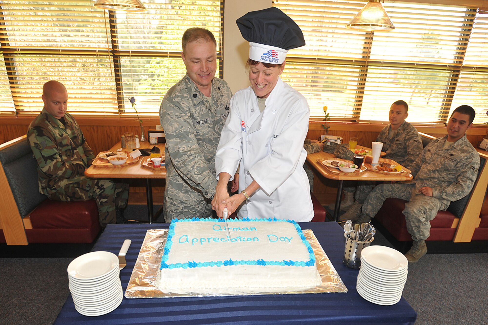 Lt. Col. Tracy Witcher, 21st Mission Support Group deputy commander, and Chief Master Sgt. Cynthia Solomito, 21st MSG superintendent, cut the Airmen Appreciation Day cake during the AAP day event at the Aragon Dining Facility May 8. The purpose of AAP was to give public thanks to Peterson Airmen for their tireless efforts toward launching and employing space power for the 21st Century. 