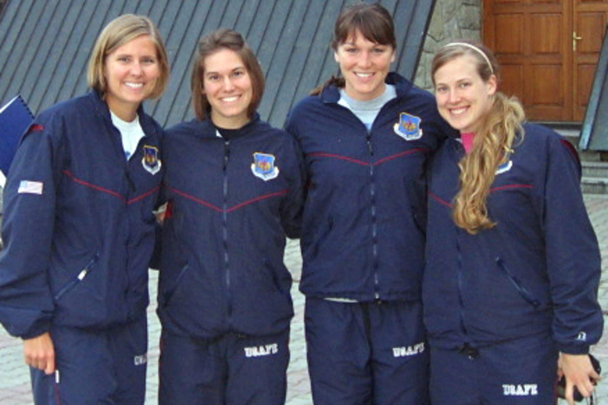 Second Lt. Lindsey Kirchhoff (second from left) joins fellow members of the winning 4 x 100 freestyle swimming relay team during the Allied Air Component Command swimming competition in Zakopane, Poland, April 16, 2009. The Air Force women's team defeated teams from Poland, Belgium, Germany, the Netherlands and the United Kingdom. The lieutenant is a section commander in the 4th Aircraft Maintenance Squadron. (Courtesy photo)