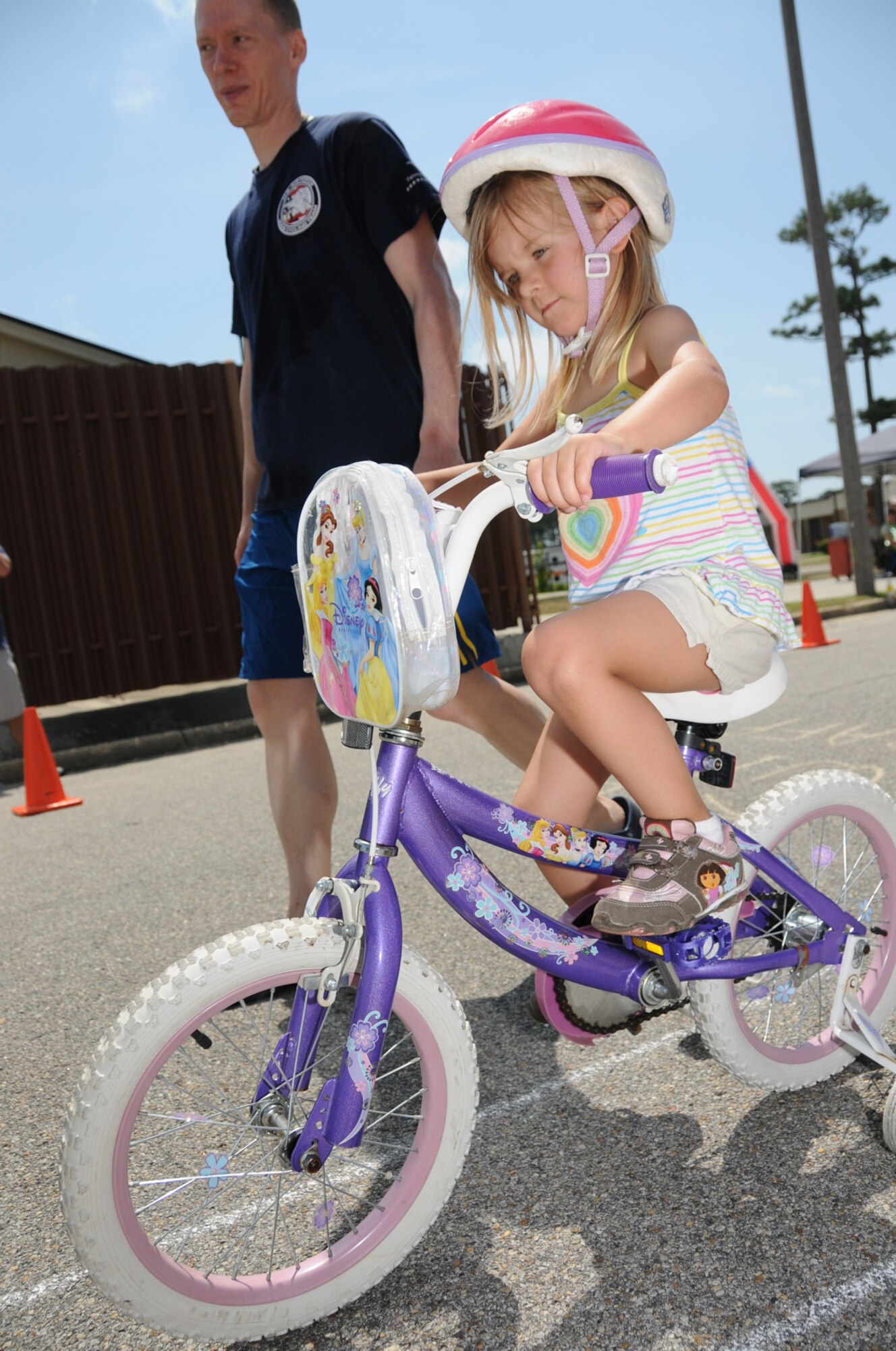 Capt. Erik Vacarelli, 81st Inpatient Operations Squadron, guides 4-year-old Natalee Cole through a bike safety obstacle course at the youth center Saturday.  Captain Vacarelli organized the bike rodeo.  Natalee’s dad is Tech. Sgt. Dirik Cole, 81st Operations Support Flight.  (U.S. Air Force photo by Kemberly Groue)