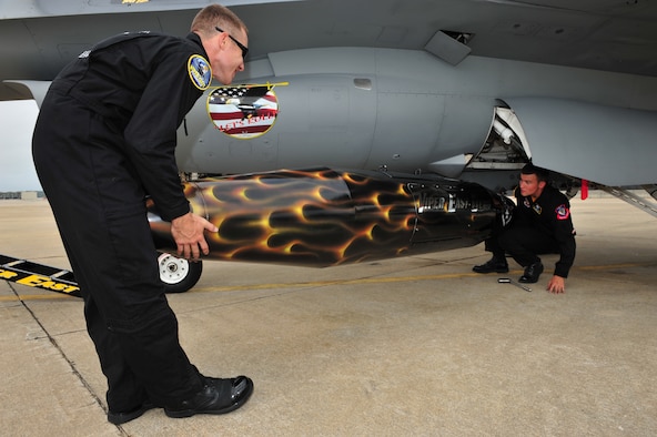 SHAW AIR FORCE BASE, S.C.- Senior Airman Anthony J. Modugno, left, and Staff Sergeant James A. Griggs, both dedicated crew chiefs of the Viper East F-16 Demonstration Team, place a travel pod into position so it can be hung on the F-16 aircraft. The pair volunteered their personal time refinishing the pod over a two-week period to bring it up to show standards, May 14, 2009. (U.S. Air Force Photo by: Tech. Sgt. Josef Cole) 
