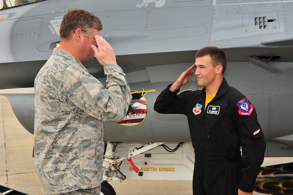 SHAW AIR FORCE BASE, S.C.- Col. Robert A. Hopkins Jr, 20th Maintenance Group commander, returns the salute of Staff Sergeant James A. Griggs, a dedicated crew chief of the Viper East F-16 Demonstration Team. Sergeant Griggs was recognized by Colonel Hopkins for volunteering his personal time refinishing a travel pod over a two-week period to bring it up to show standards, May 14, 2009. (U.S. Air Force Photo by: Tech. Sgt. Josef Cole) 
