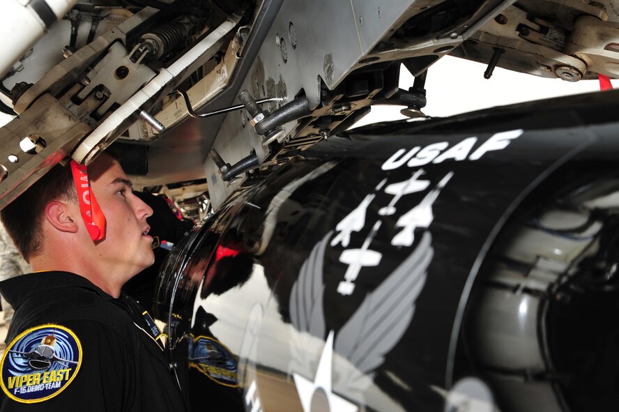 SHAW AIR FORCE BASE, S.C.- Staff Sergeant James A. Griggs, a dedicated crew chief of the Viper East F-16 Demonstration Team, aligns a travel pod into position so it can be hung on the F-16 aircraft. Sergeant Griggs volunteered his personal time, along with Senior Airman Anthony J. Modugno, refinishing the pod over a two-week period to bring it up to show standards, May 14, 2009. (U.S. Air Force Photo by: Tech. Sgt. Josef Cole) 
