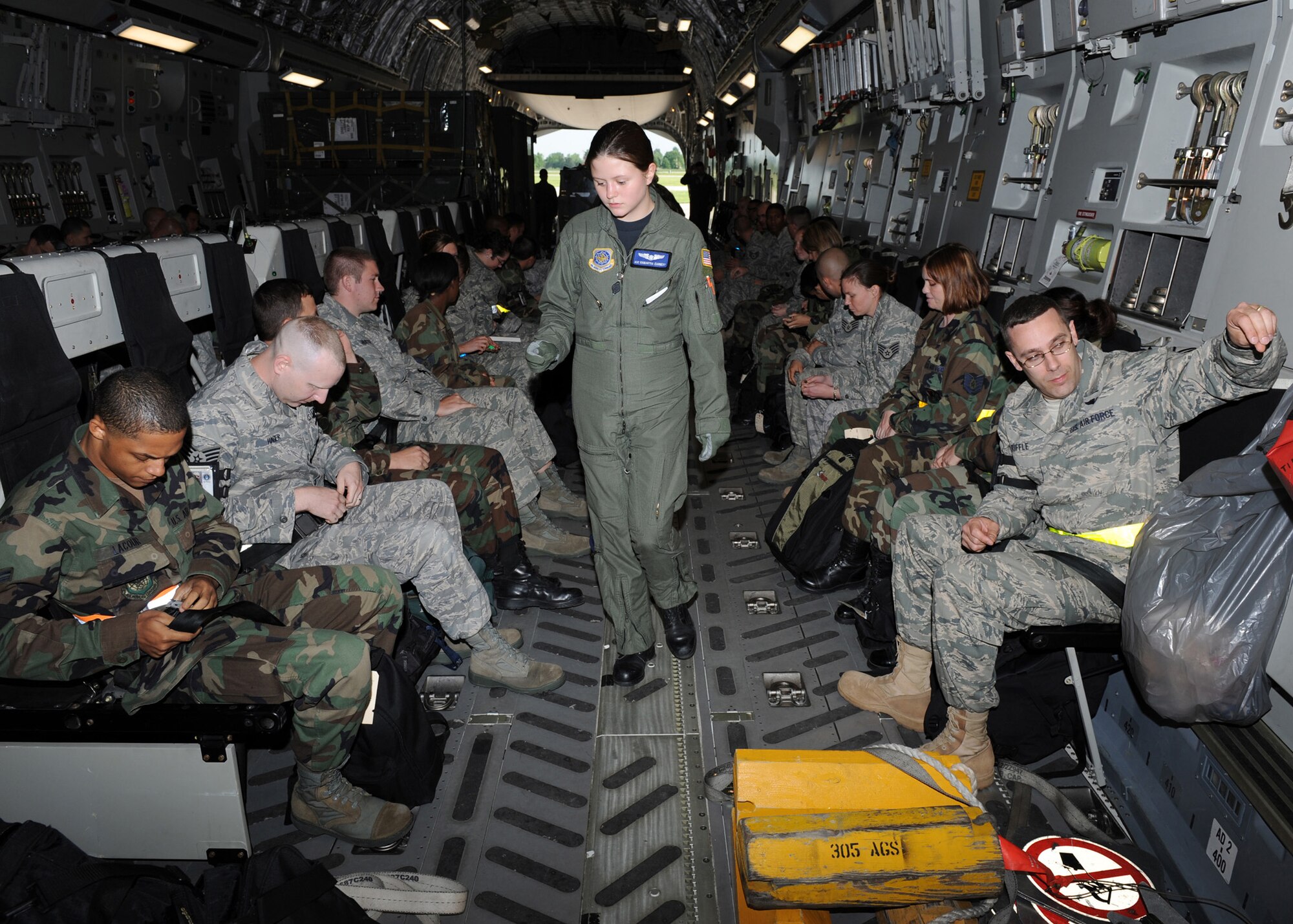 SCOTT AIR FORCE BASE, Ill. -- Airman 1st Class Samantha Earnest, loadmaster with the 6th Airlift Squadron at McGuire Air Force Base, N.J., counts the passengers aboard a C-17 Globemaster at Scott Air Force Base, Ill., May 12. The C-17 Globemaster III and crew transporting 375th Airlift Wing Airmen to Volk Field, Wisc., for the first of many operational readiness inspection preparation exercises, is based out of McGuire.  (U.S. Air Force photo/Staff Sgt. Paul Villanueva II)