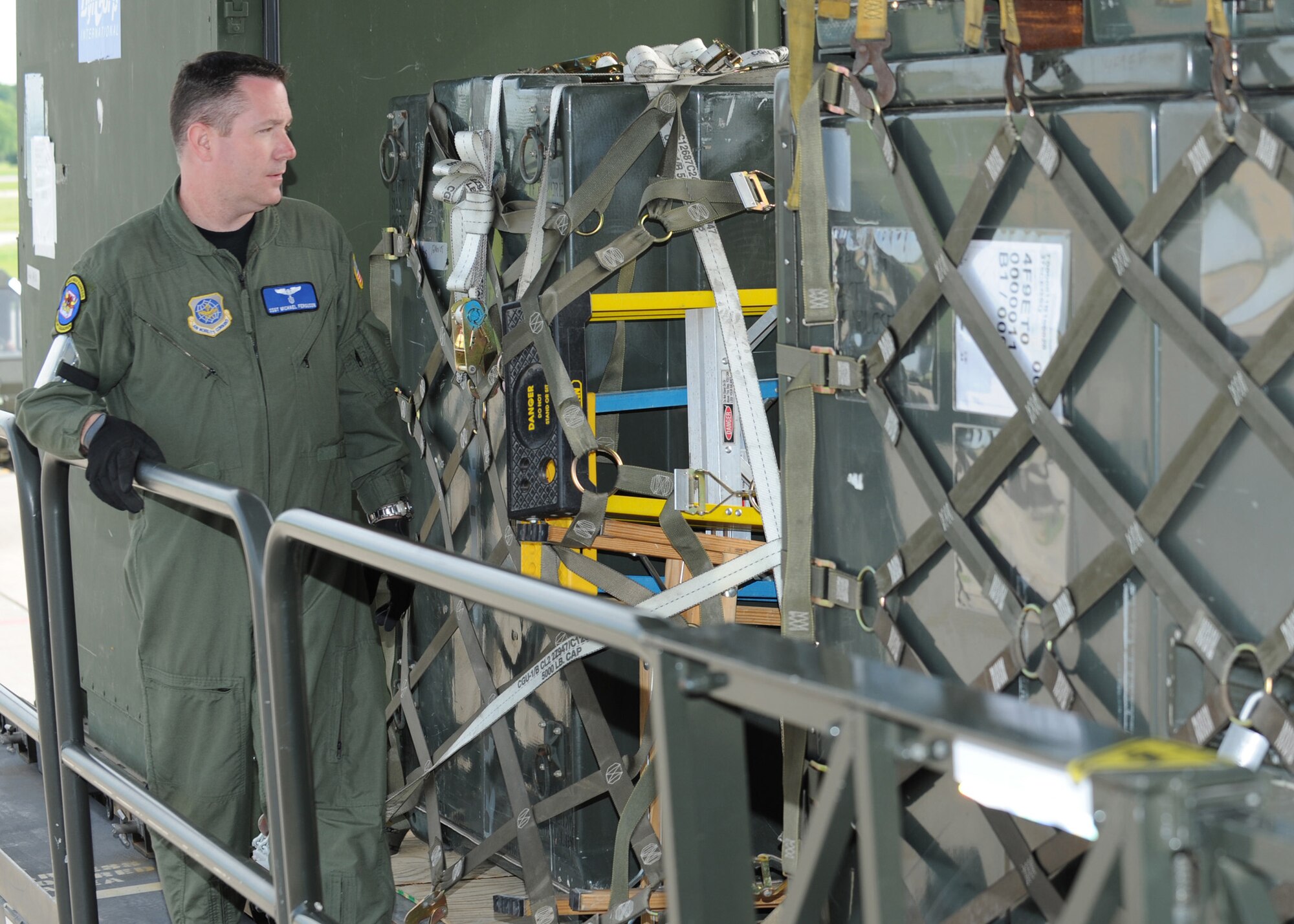 SCOTT AIR FORCE BASE, Ill. -- Staff Sergeant Michael Ferguson, loadmaster with the 6th Airlift Squadron at McGuire Air Force Base, N.J., inspects pallets of cargo before they are loaded in to a C-17 Globemaster III at Scott Air Force Base, Ill., May 12. The cargo will be flown to Volk Field, Wisc., where 375th Airlift Wing Airmen will train with the Minnesota Air National Guard 133rd Airlift Wing and the 94th Arial Port Squadron (Reserve) from Robins Air Force Base, Ga. in preparation for the wing's for the operational readiness inspection in March 2010. (U.S. Air Force photo/Staff Sgt. Paul Villanueva II)